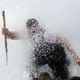 A ‘percebeiro’ emerges from a wave.